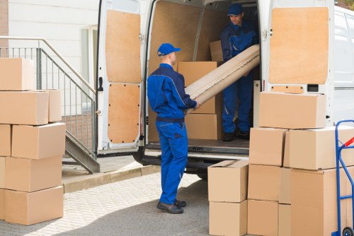 Man with a van pricing details for a local Morden move