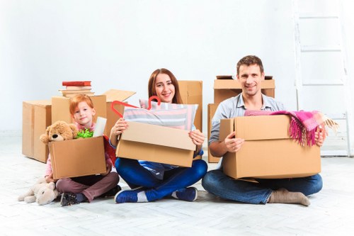 Movers handling desks and IT equipment during an office move