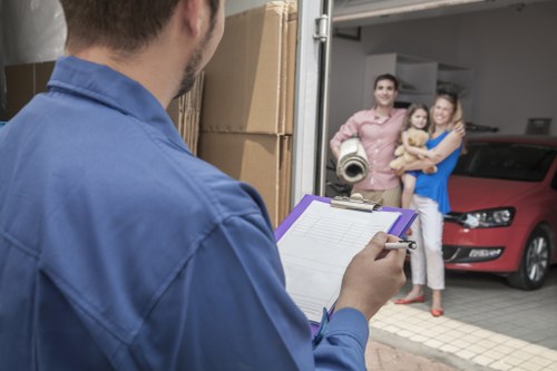 Household boxes and furniture being loaded by movers in Morden