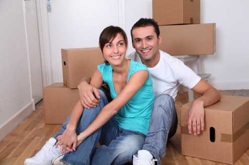 Packed office boxes and furniture ready for transport in Morden